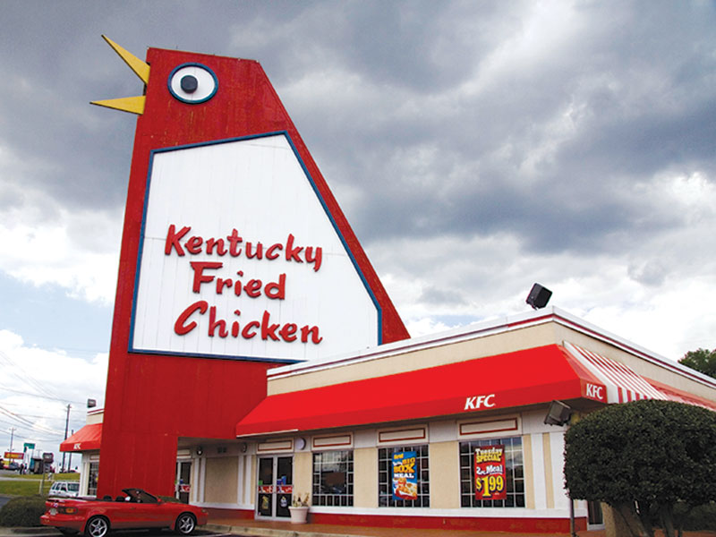 kentucky fried chicken restaurant with large chicken sign